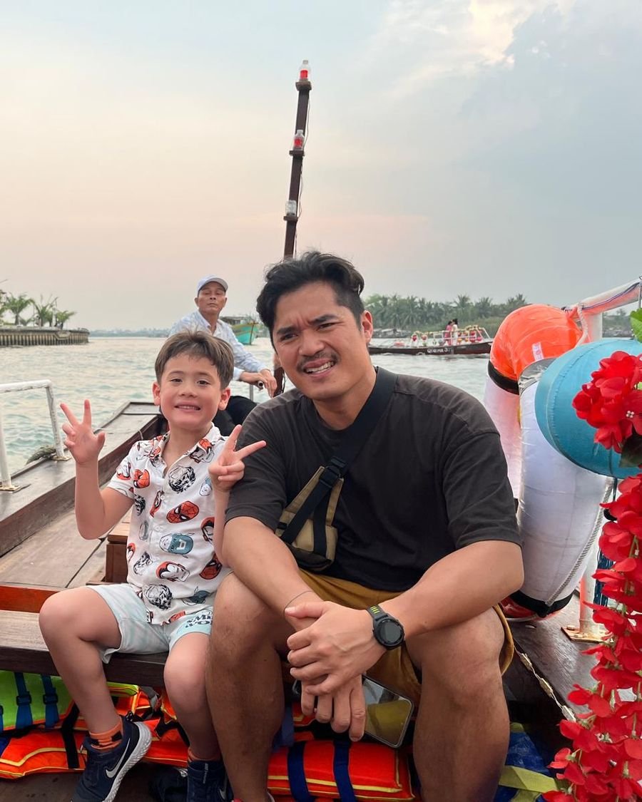 Noah and Vinh on a boat in Hoi An